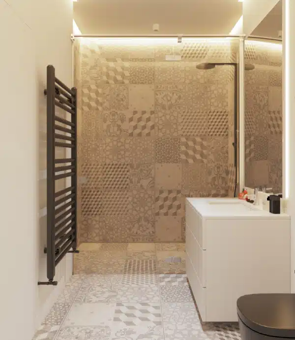 Modern bathroom with patterned beige tiles on the floor and shower wall, a black towel radiator, a white vanity with sink, a large mirror, and a black toilet. Warm lighting illuminates the space.